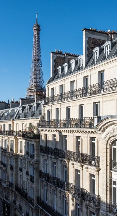 Luxurious Haussmann apartment with iconic Eiffel Tower views, elegant wrought-iron balconies, soaring ceilings, and abundant natural light. Prime Paris location.